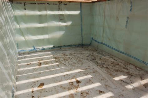 Cech House: Basement vapor barrier and floor framing