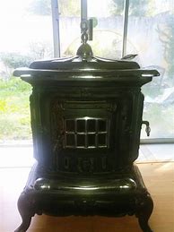 Image result for Antique Cast Iron Parlor Stoves for Sale