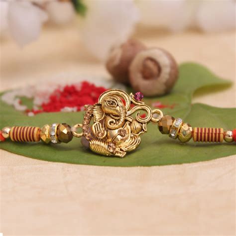 Send Aesthetic Golden Ganesha Rakhi Online - RKH19-87540 | Giftalove