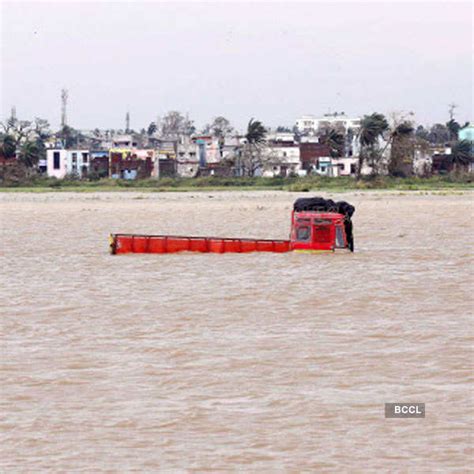 People stuck in water on a waterlogged road after heavy rains in Patna.