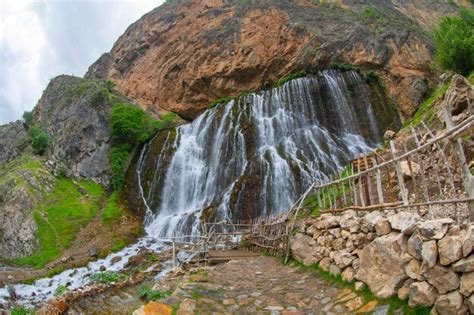 Scenic waterfall cascading down a mountain cliff | Premium Photo