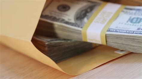 Slow Pan of Stacks of One Hundred Dollar Bills iIn Envelope 15639981 ...