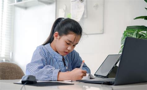 Asian girl children using laptop computer tablet , studying through ...