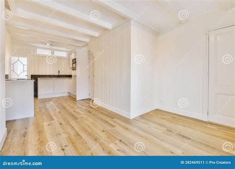 A Renovated Living Room with White Walls and Wood Floors Stock Image ...