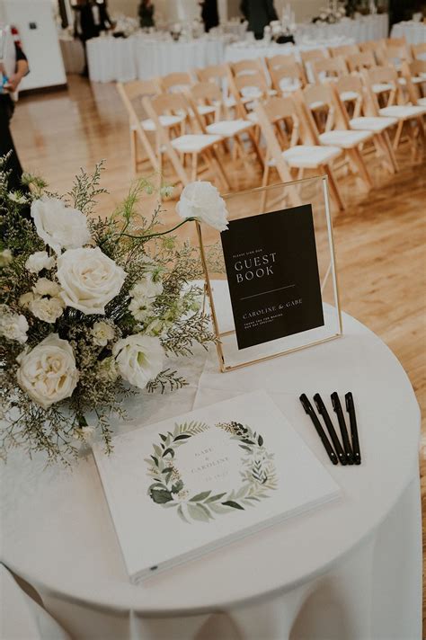 Simple Modern Wedding Guest Book with All White Florals & Black Sign ...