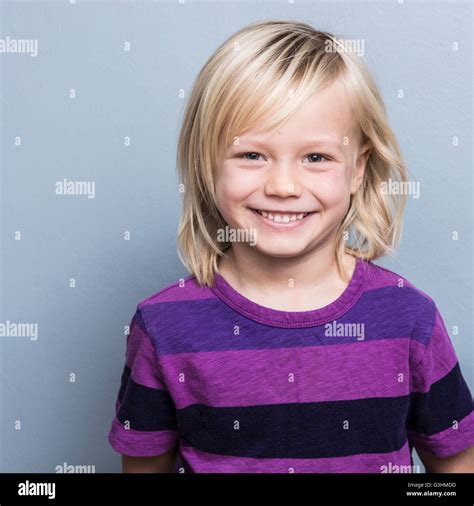 Portrait of blonde haired boy looking at camera smiling Stock Photo - Alamy