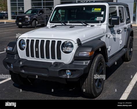 A new, white four door Jeep Wrangler for sale at a dealership in Monroeville, Pennsylvania, USA ...