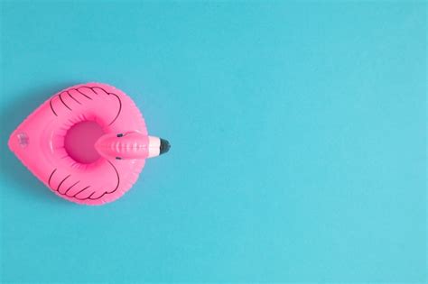 Inflatable flamingo on blue background pool float | Premium Photo