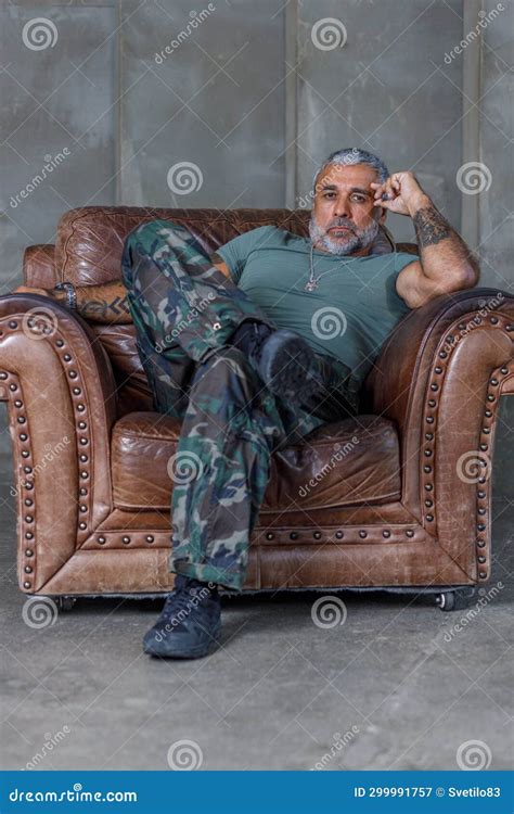 A Soldier in Camouflage, a Soldier Stands Against the Wall.a Mature ...