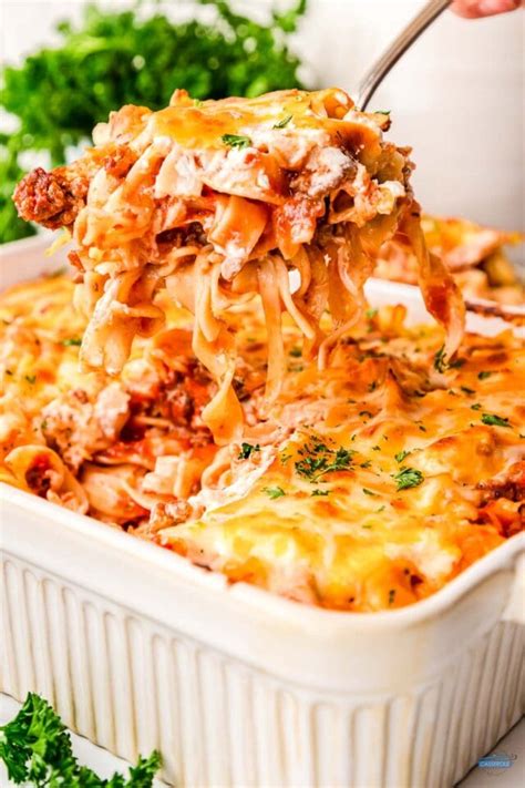 top-down view of a white 9x13 casserole dish of Grandmaâ��s ground beef casserole with a scoop out a