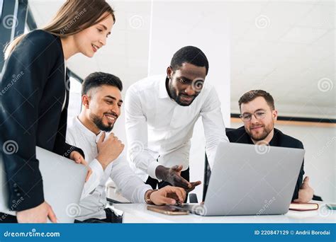 Group of Multiracial White Collar Workers in the Office Behind a Laptop. Stock Image - Image of ...