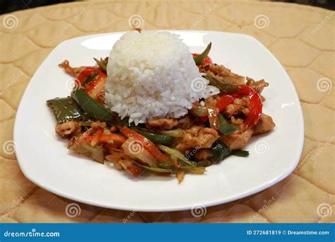 A bowl of slow cooker pepper steak, served over white rice