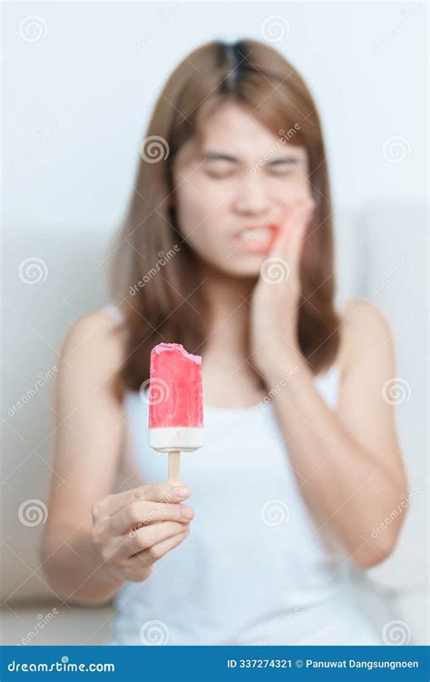 Teeth Sensitive To Cold Concept. Woman Hold Ice Cream And Having ...