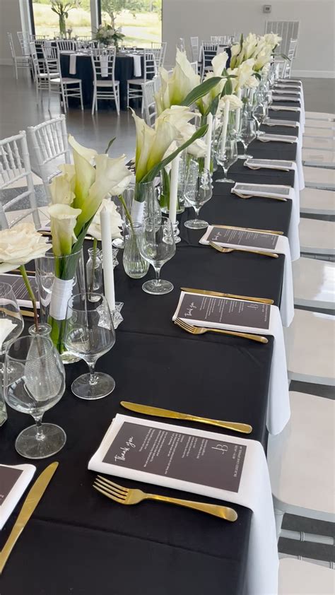 Elegant Wedding Table Decoration with White Flowers and Black Linens