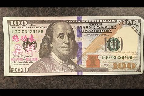 Counterfeiter Tries to Pass $100 Bills with Chinese Writing