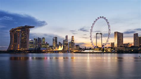 Aerial view of Marina Bay Sands and the Singapore skyline at dusk, seen from above the bay