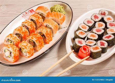 Different Sushi Rolls with Rice, Vegetable, Seafood on Ceramic Stock ...