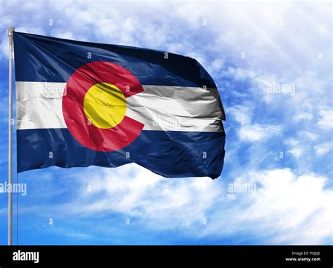 flag State of Colorado on a flagpole in front of blue sky Stock Photo ...