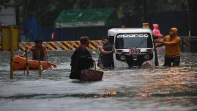 Monsoon: Typhoon Gaemi floods Manila with knee-deep water, 16 flights ...