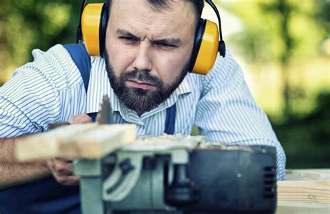 Worker beard man with circular saw | Premium Photo