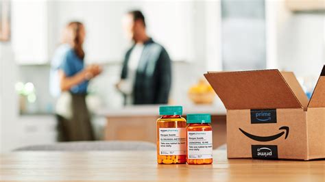 Two bottles of medication are on a table with an Amazon box next to ...
