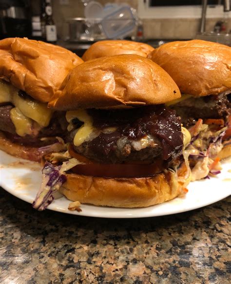Ground chuck burgers, wine braised sweet onion, sliced tomatoes, slaw ...