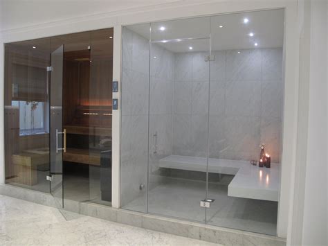 This stylish steam room has white Corian benches and large format tiles ...