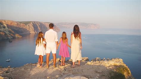Happy family of four walking in the mountains on the sunset 19988068 ...