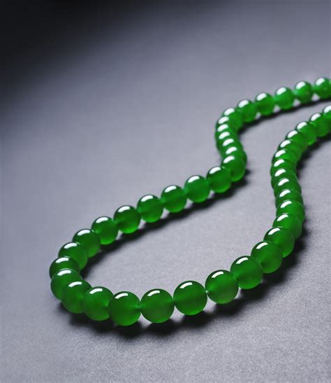 AN EXTREMELY RARE AND EXCEPTIONAL “IMPERIAL GREEN” JADEITE BEAD AND ...