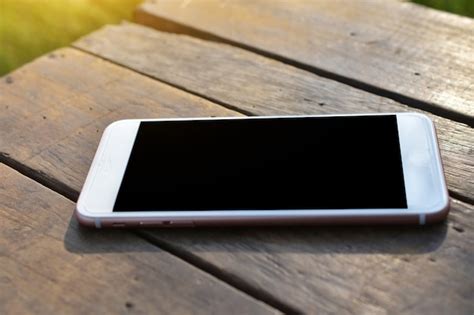 Mobile smart phone is on wooden table | Premium Photo
