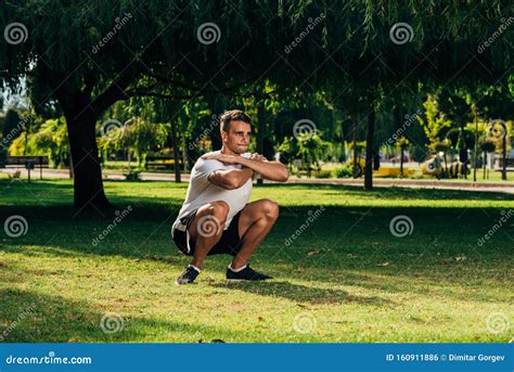 Fitness Man Training Air Squat Exercise on Green Meadow Stock Photo ...