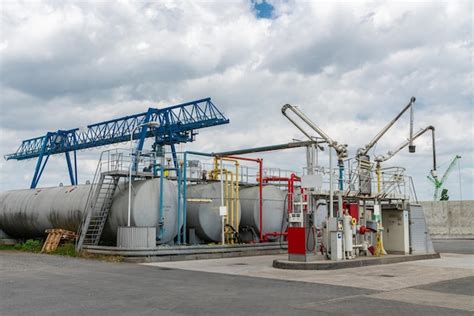 Large industrial filling station with big fuel tanks and overhead crane ...