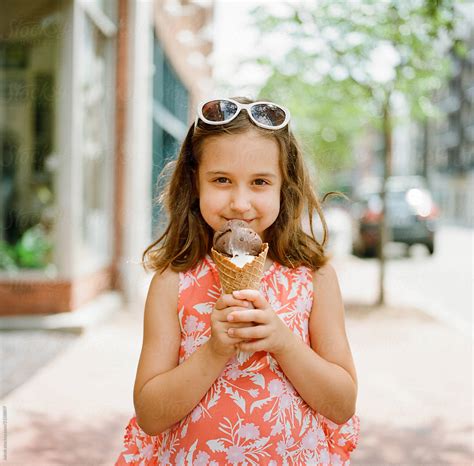 "Cute Young Girl Excited To Eat A Big Ice Cream" by Stocksy Contributor "Jakob Lagerstedt" - Stocksy
