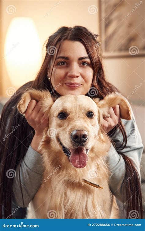 Playing with Ears, Front View, Portrait. Woman is with Golden Retriever ...