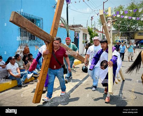 On Holy Friday in Iztapalapa, faithful people carry large wooden ...