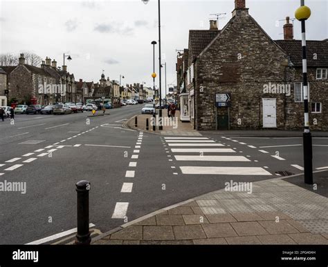 A zebra crossing providing pedestrian priority at a side road junction ...