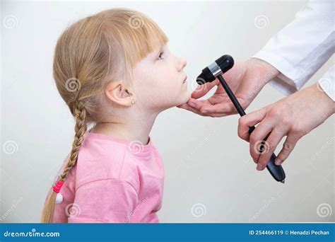 A Neuropathologist Checks the Mandibular Reflex in a 5-year-old Girl. Close-up, Neurologist ...