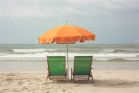 Two beach chairs and umbrella on the tropical beach with sea and sky ...