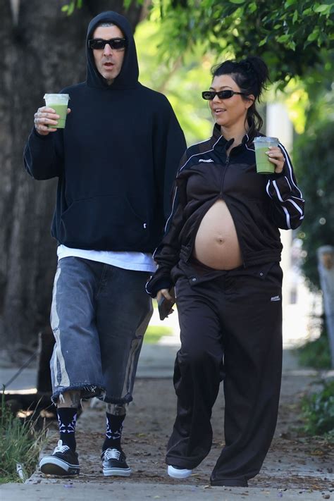 Pregnant Kourtney Kardashian shows off baby bump in tracksuit with ...