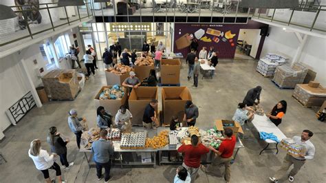 Golden Harvest Food Bank volunteers help fill food bags