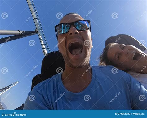 Man and Woman on a Roller Coaster Ride with Emotion on Their Faces ...