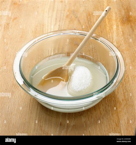 Sugar dissolving in a bowl of water Stock Photo - Alamy