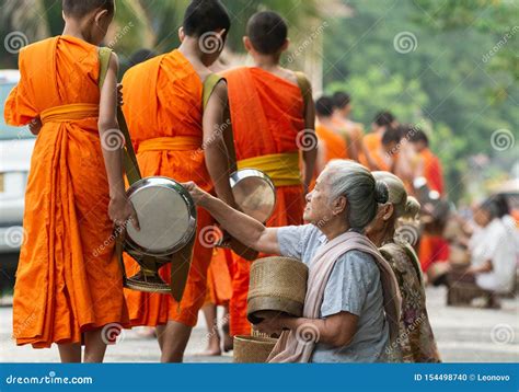 Laotian People Making Offerings To Buddhist Monks during Traditional Alms Giving Ceremony in ...