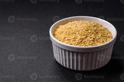 Raw whole grain orzo pasta as an ingredient for a delicious dish ...