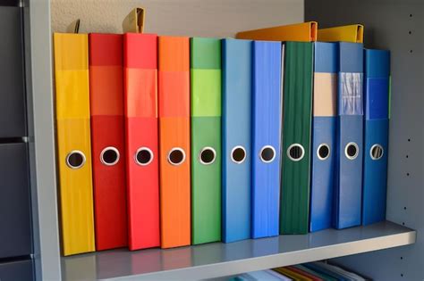 Colorful office binders on a shelf | Premium Photo