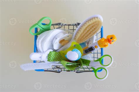Flat lay on shopping basket with baby care items - scissors ...