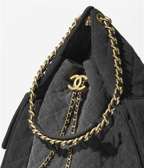 Chanel 25 medium handbag, Washed denim & gold-tone metal, black ...
