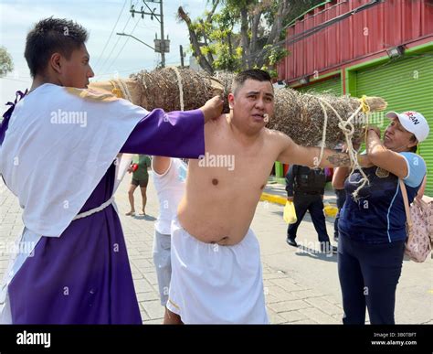 On Holy Friday in Iztapalapa, young faithful man carries a large pack ...