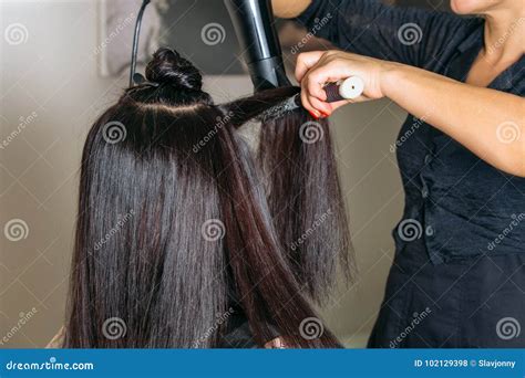 Hairdressers Hands Drying Long Black Hair with Blow Dryer and Round ...