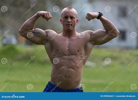 Bodybuilder Performing Front Double Biceps Poses in Park Stock Image ...